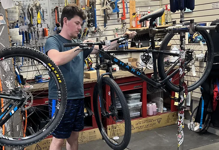 Outdoor Expert servicing Bikes at Sun & Ski Sports