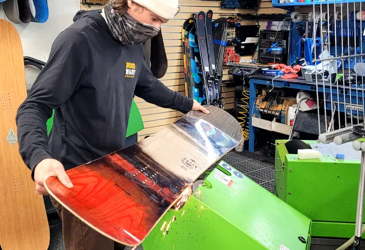 Outdoor Expert servicing a Snowboard at Sun & Ski Sports