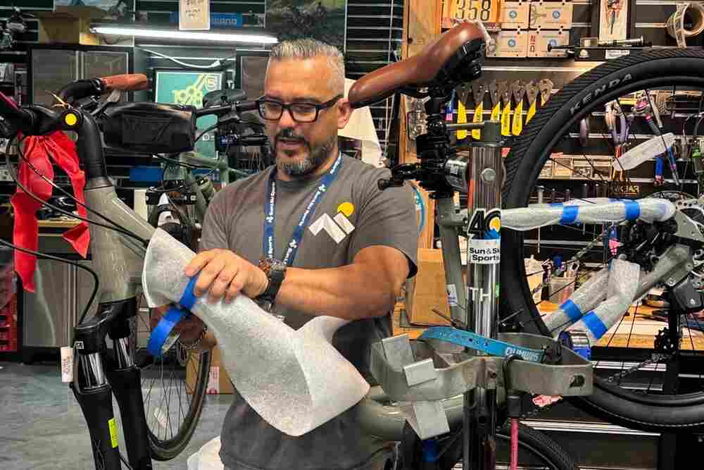 Bike technician working on bike in Sun & Ski Sports bike shop 