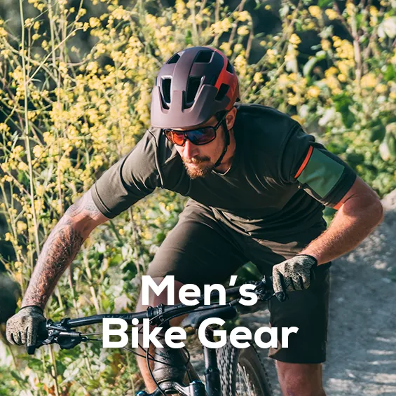 A Man mountain biking with gear from Pearl iZUMi and Lazer including bike helmet, sunglasses, shirt & shorts and gloves. Shop All men's bike gear from sun & ski sports. 