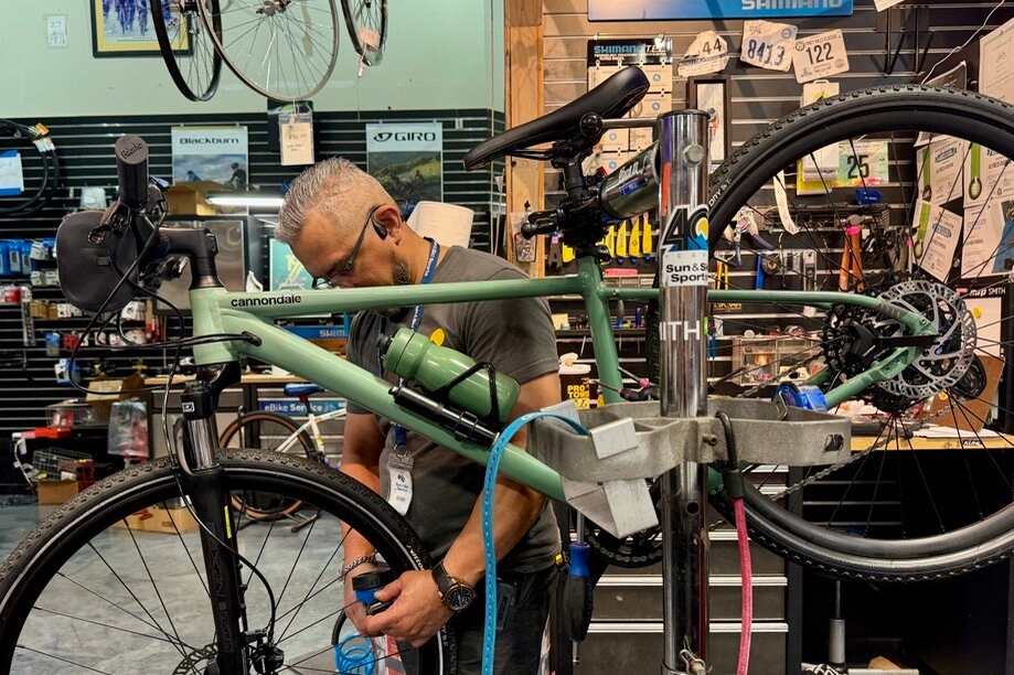 Bike technician working on bike in Sun & Ski Sports bike shop 