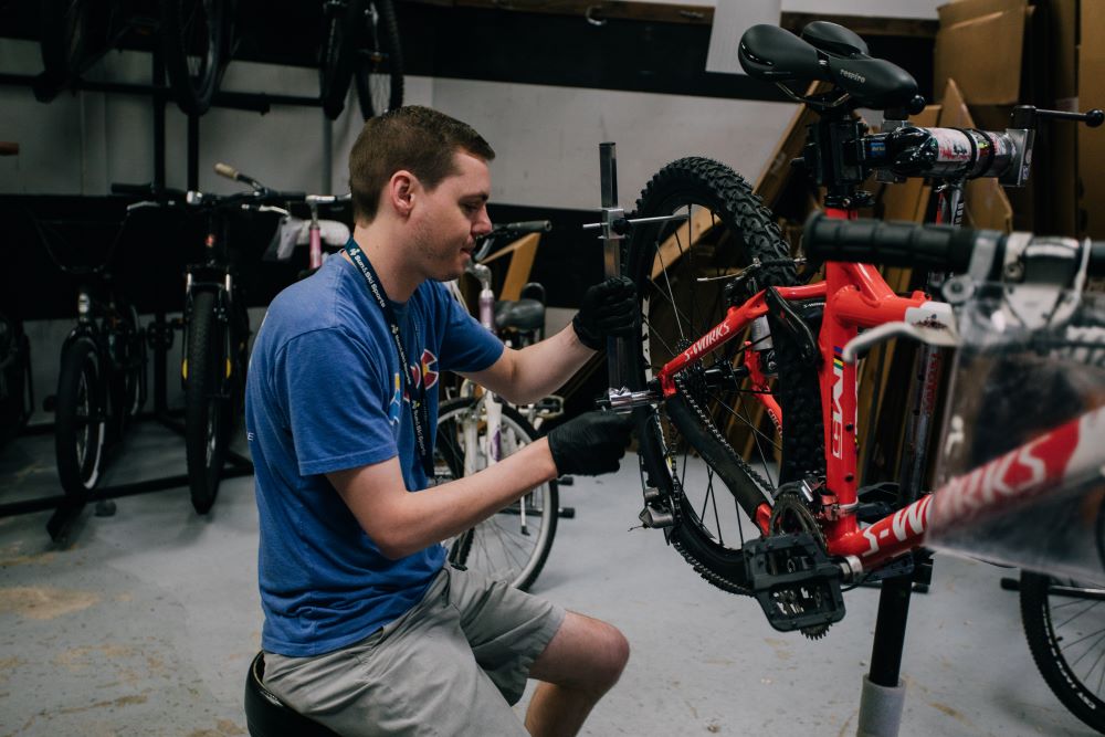 Bike technician working on bike in Sun & Ski Sports bike shop 