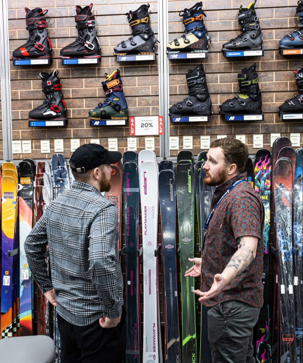 Sun & Ski Sports Outdoor Expert helping a customer find the right ski gear