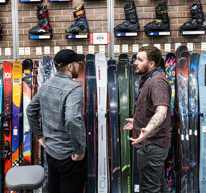  An Outdoor Expert Helping a Customer With Equipment Rentals At Sun & Ski Sports