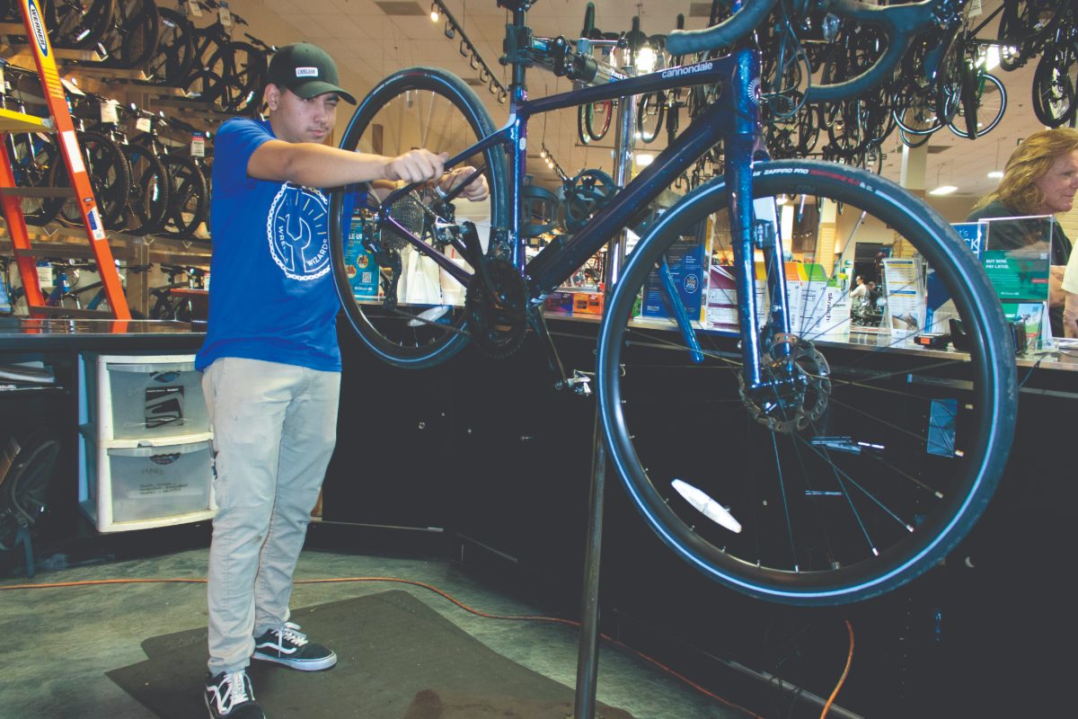 A bike technician fixing a bicycle at Sun & Ski