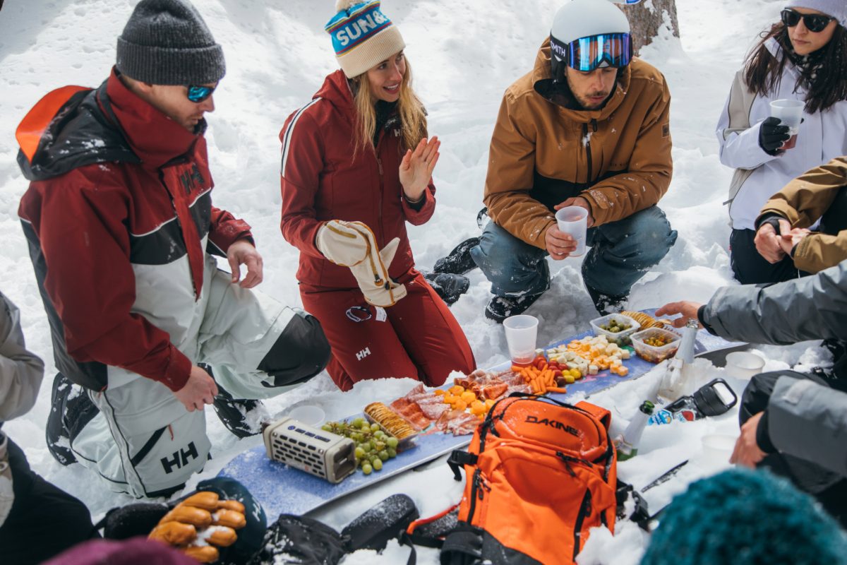 A group of skiers wearing Sun & Ski Sports ski and outdoor gear.
