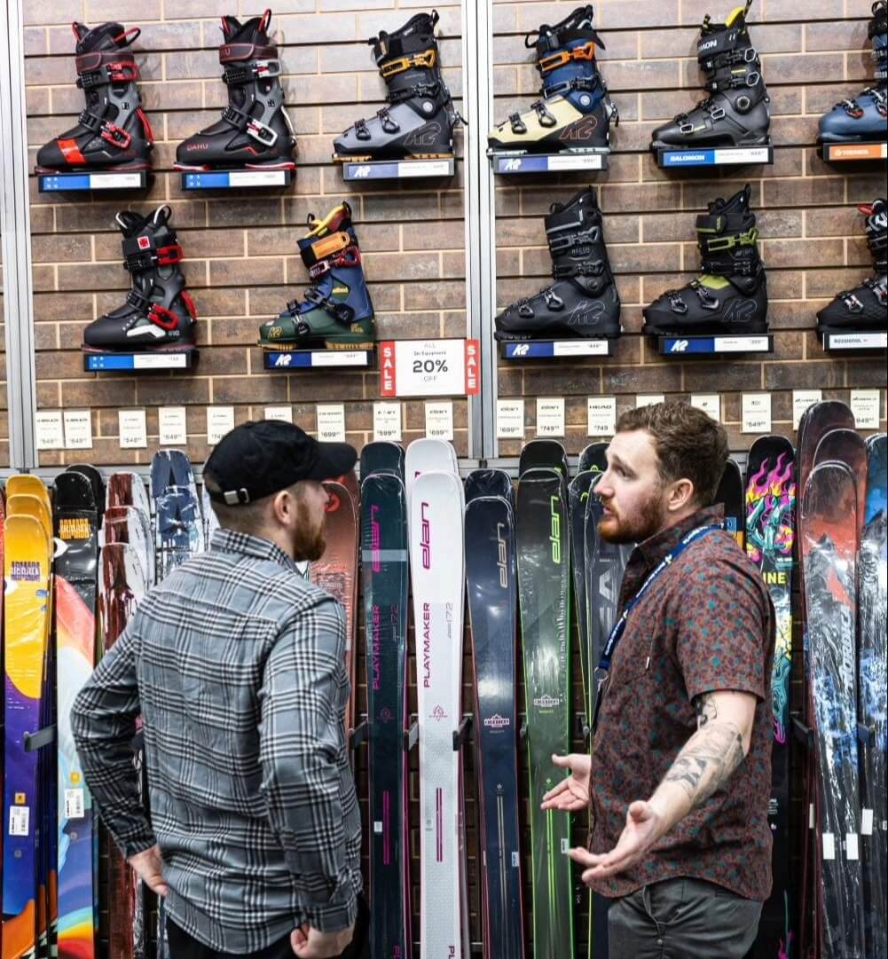 Sun & Ski Sports Outdoor Expert helping a customer find the right ski gear