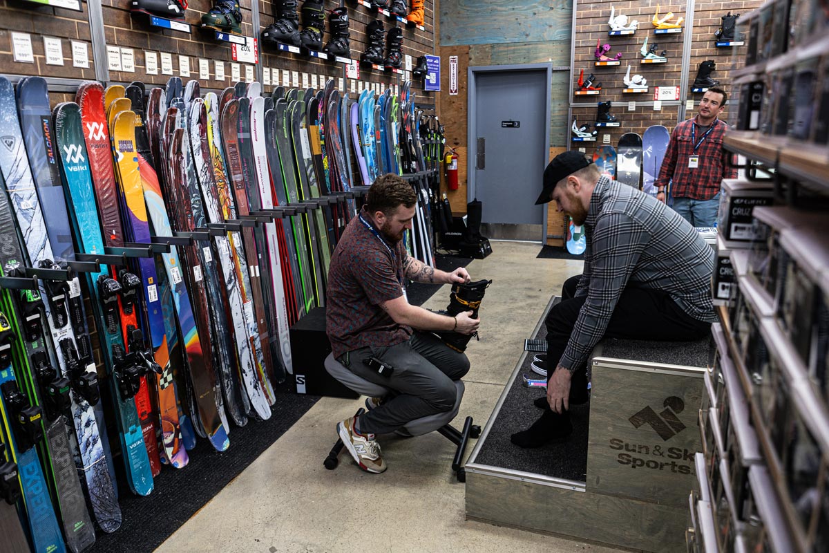 A customer being fit for boots at Sun & Ski Sports