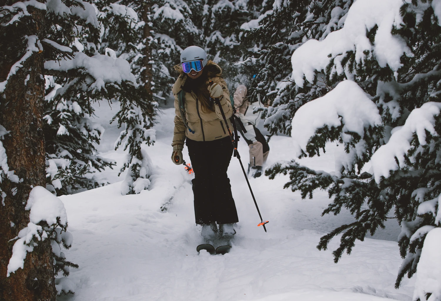Female skier in high-quality ski gear from Sun & Ski Sports.