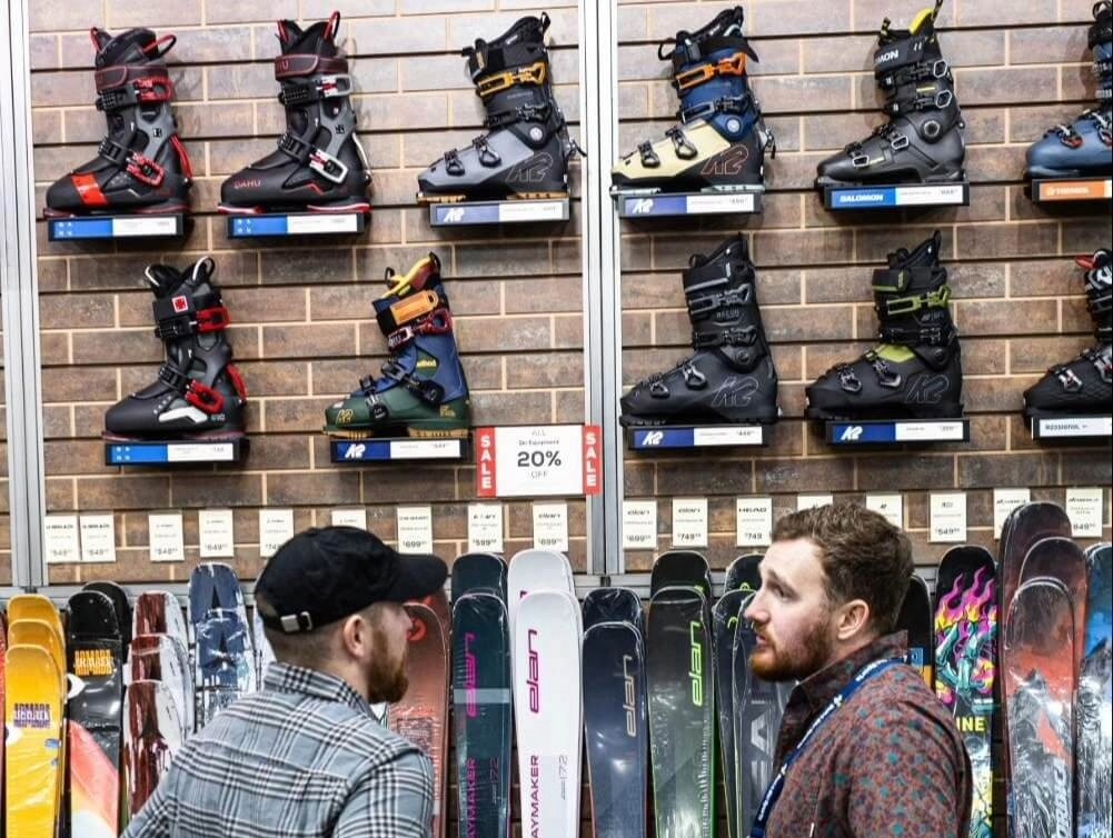 An Outdoor Expert helps a customer with their ski shop needs.