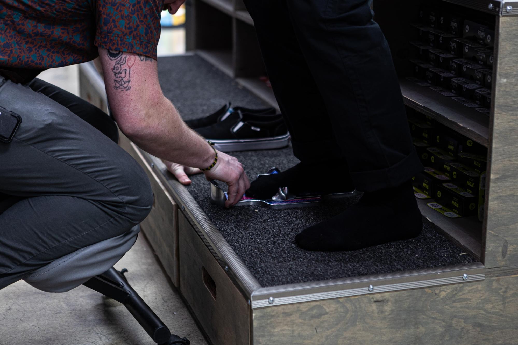 Sun & Ski staff member helping choose the right snowboard