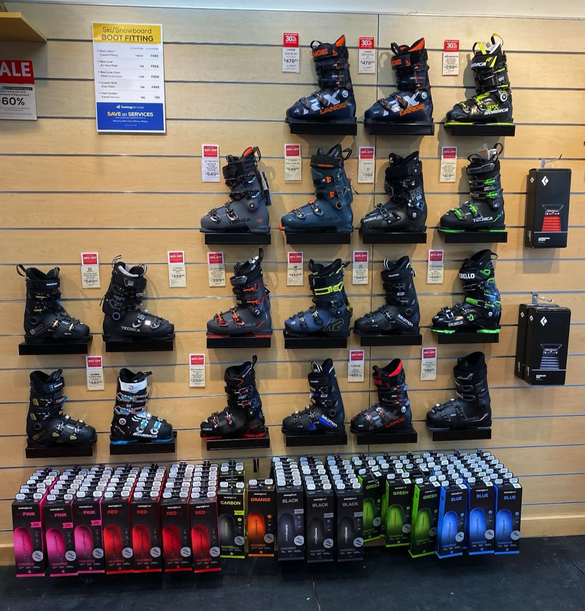 A snowboarder connecting their boots to their board with secure bindings.