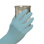 AloeSense nitrile exam gloves on hands holding beaker