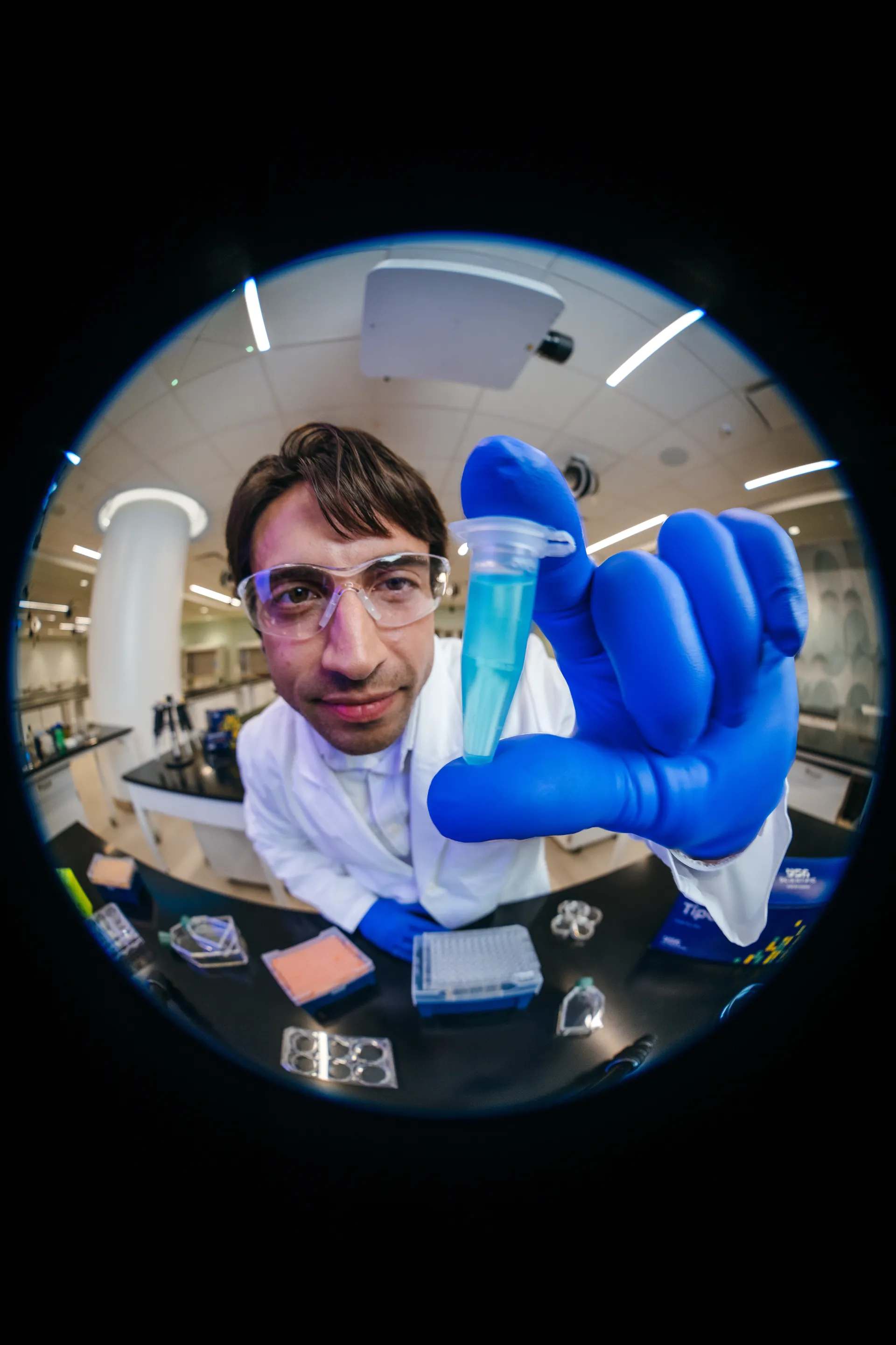 Scientist presenting a sample under circular lens framing