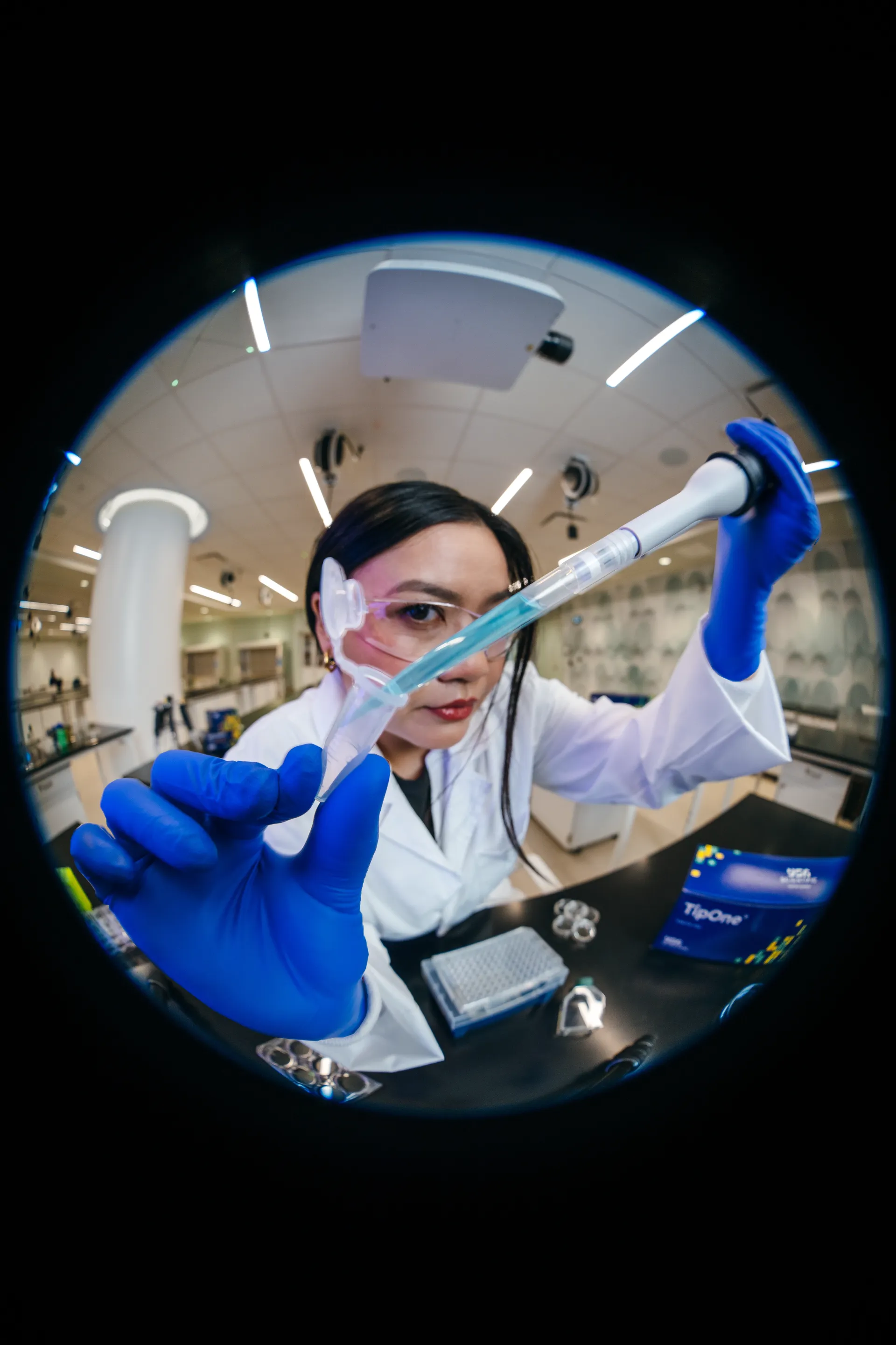 Scientist pipetting liquid into a microcentrifuge tube